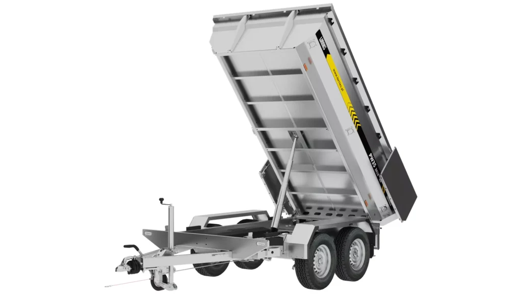 Silver two-axle utility trailer with a box raised at an angle, exposing the underside. The trailer is equipped with hydraulic supports and is designed for dumping or unloading materials.