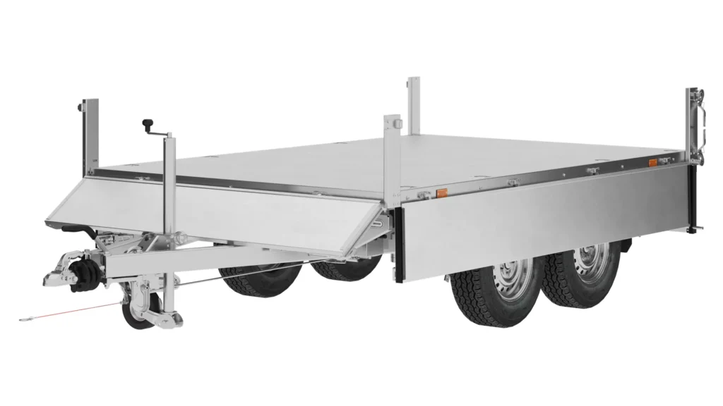 The PW27-3018 (KIPER) dump trailer is a silver flatbed utility trailer with double axles, four wheels, a sturdy metal frame, side panels and a tow hook. The trailer is displayed on a white background.